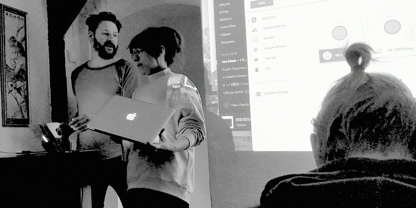 Two participants presenting what they built from a laptop.