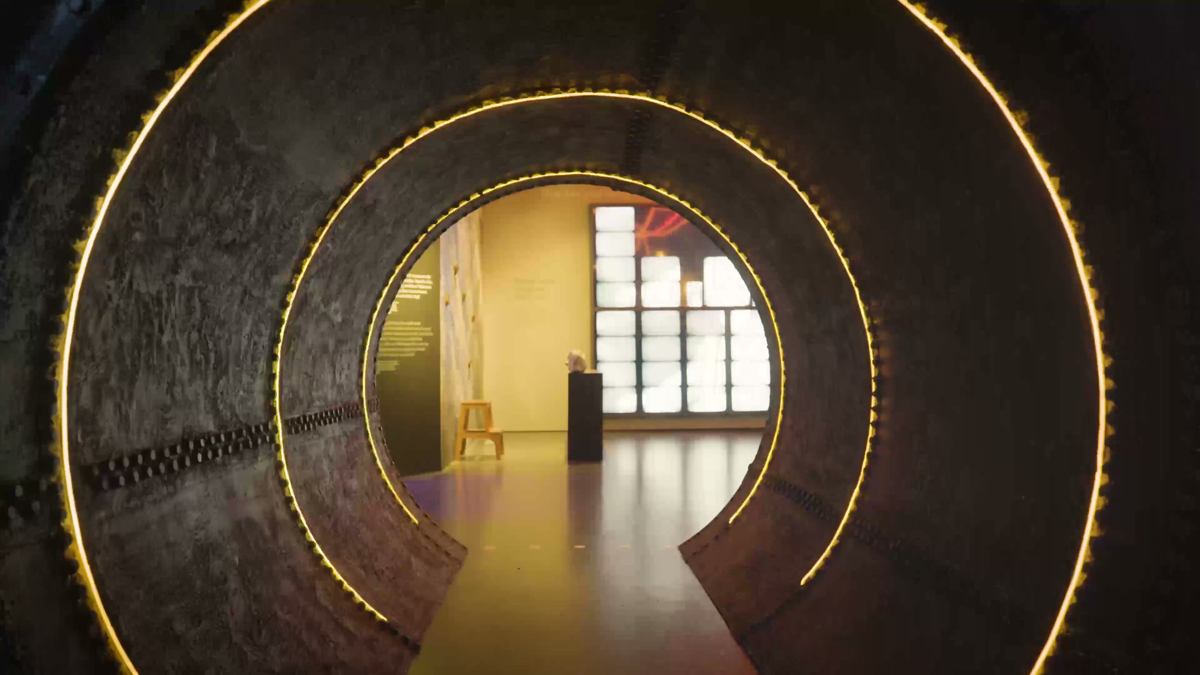 Inside the turbine: a round tunnel lined with rings of warm light, room 2 at the end
