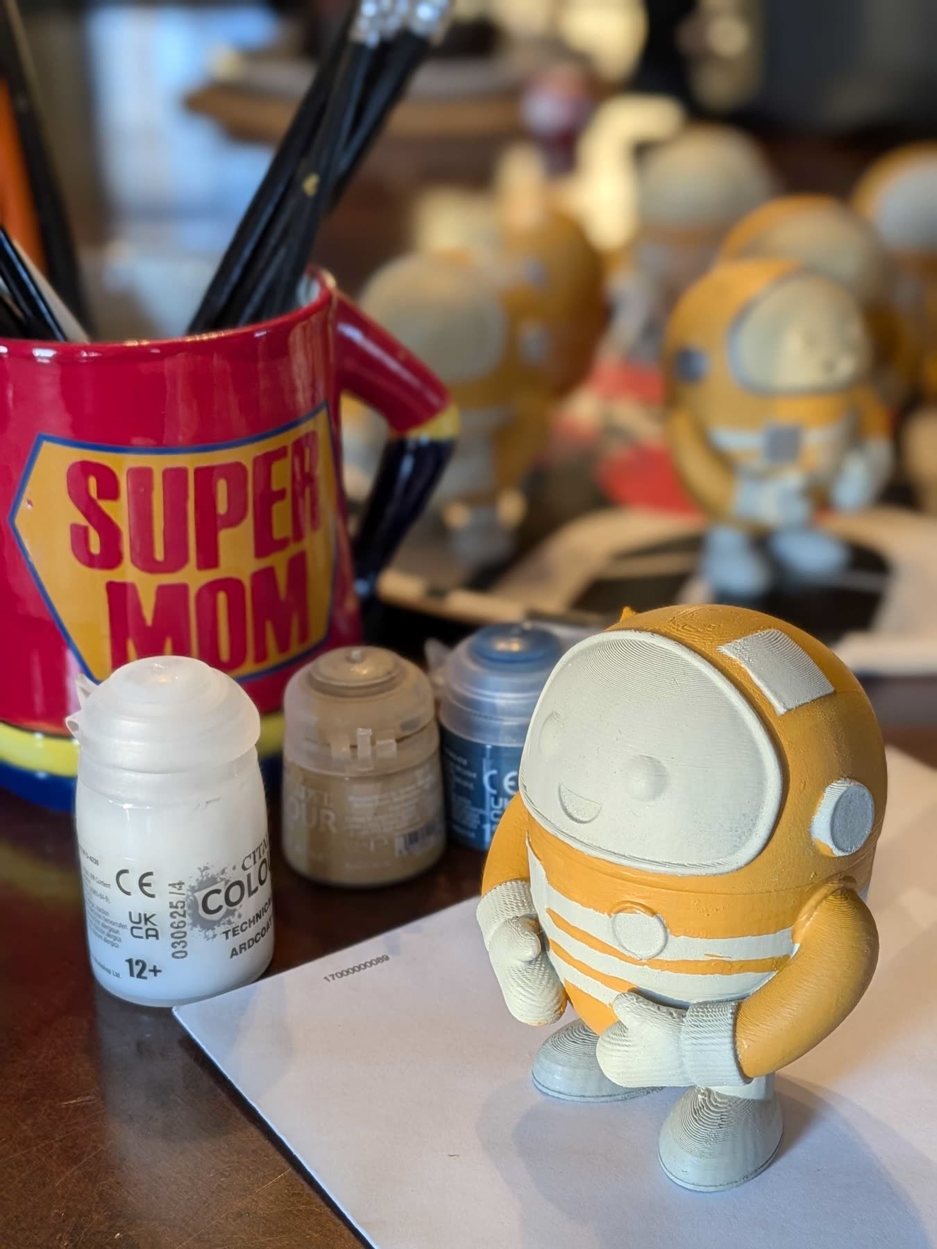 A half-painted traveller next to paint pots