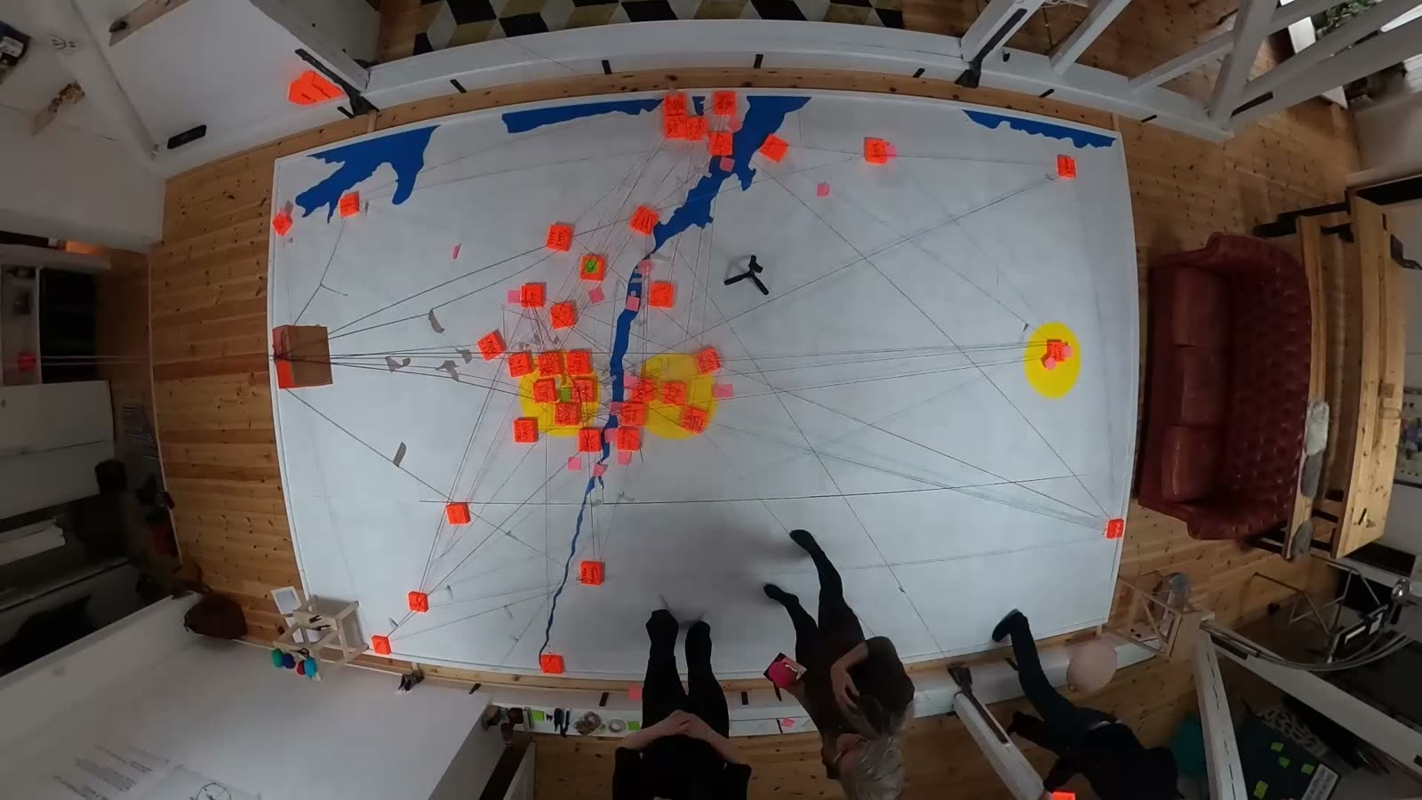The floor covered in orange blocks and yarn